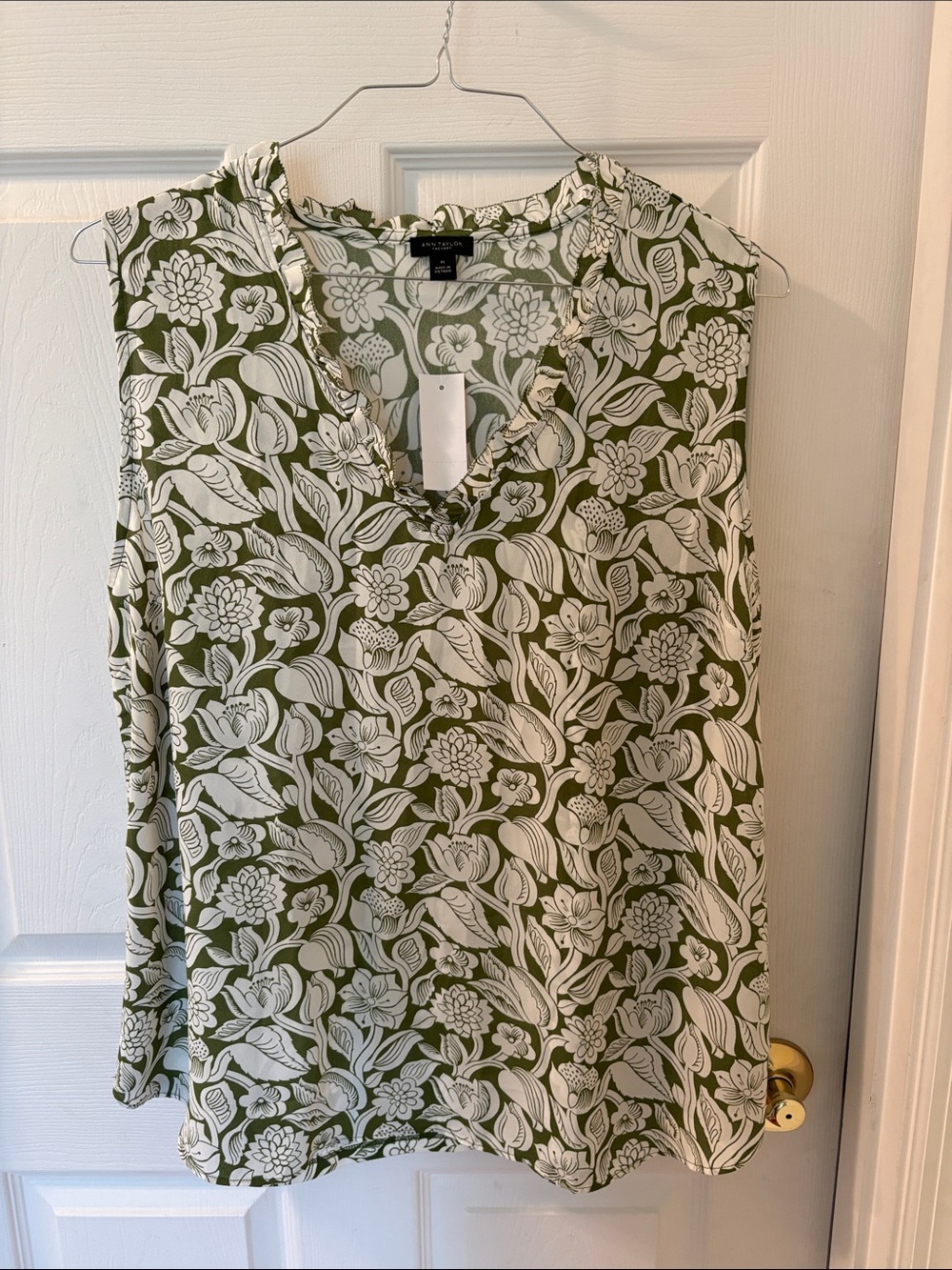 Green and white floral sleeveless blouse
